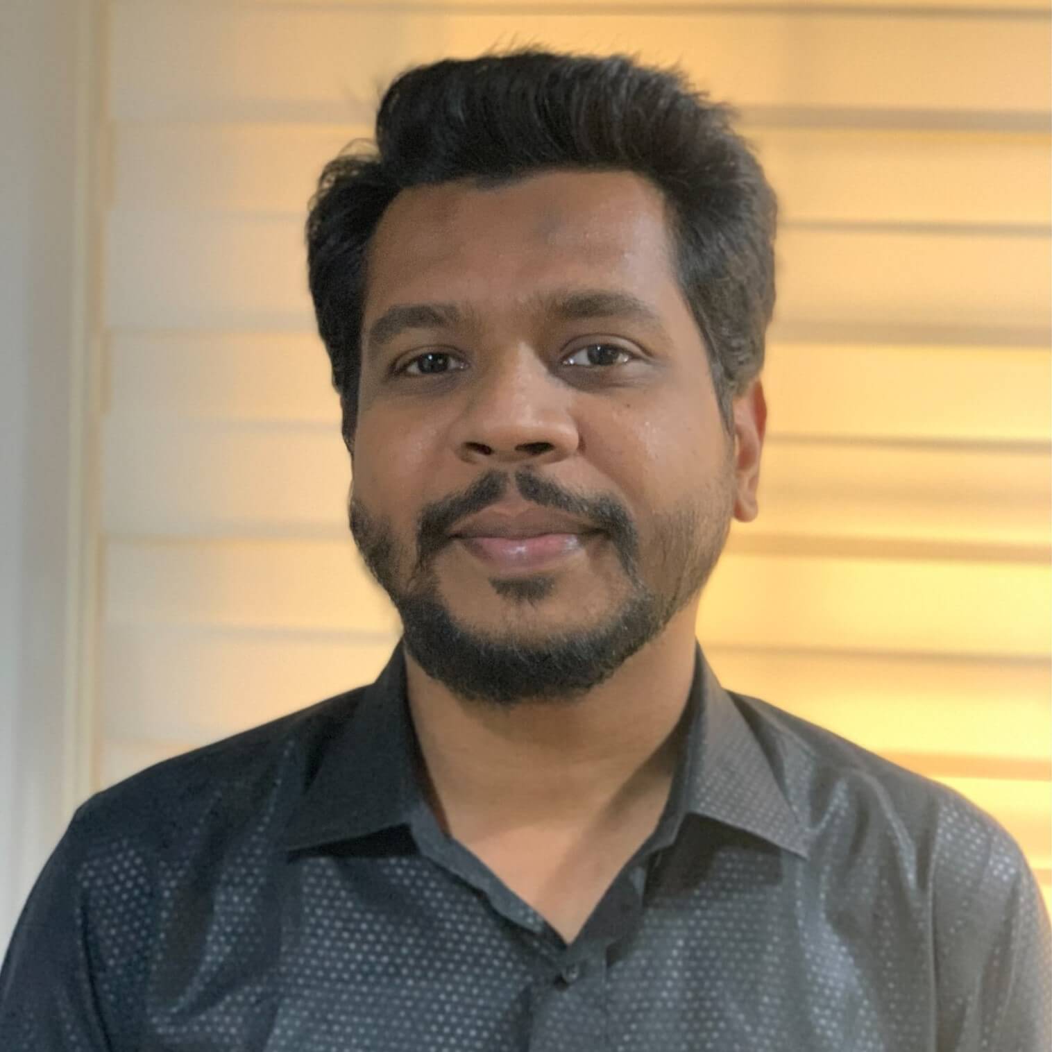 A bearded man in a black shirt, as SEO Specialist Masum Hossain from Rankupper.