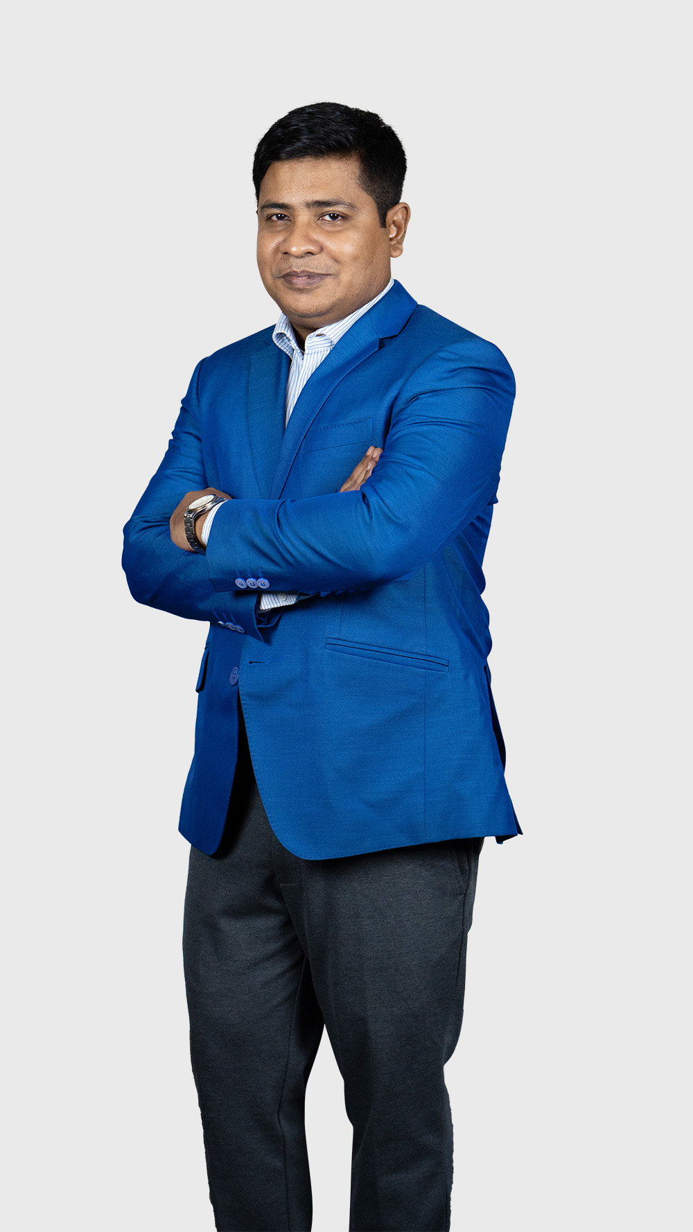 Chairman Sumon Chowdhury rankupper stands confidently in a blue suit and tie, arms crossed, conveying authority.