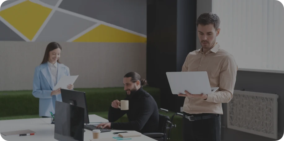 A man and woman stand together in front of a computer, engaged in a work process on the Rankupper.
